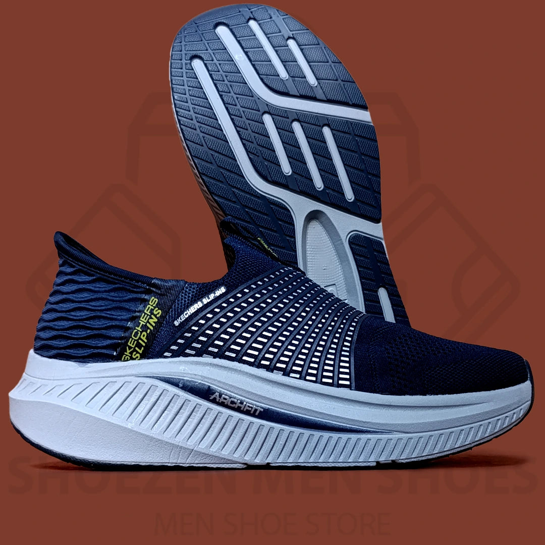 ARCHFIT SLIP-INS SKECHERS  - SHOEZEN MEN SHOES - Navy running shoes with white soles on a brown background