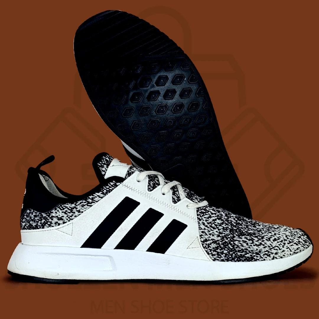 Adi XPLR 'Oreo' Joggers - Shoezen Men Shoes - Black and white sneaker with patterned sole on a brown background