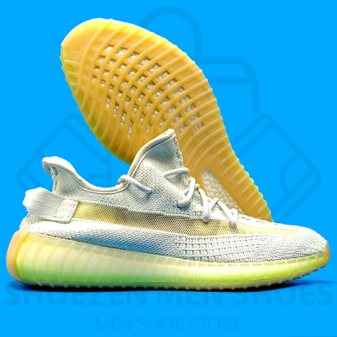 Adi Yeezy Boost 350 V2 Joggers - Shoezen Men Shoes - White and yellow sneaker on a blue background