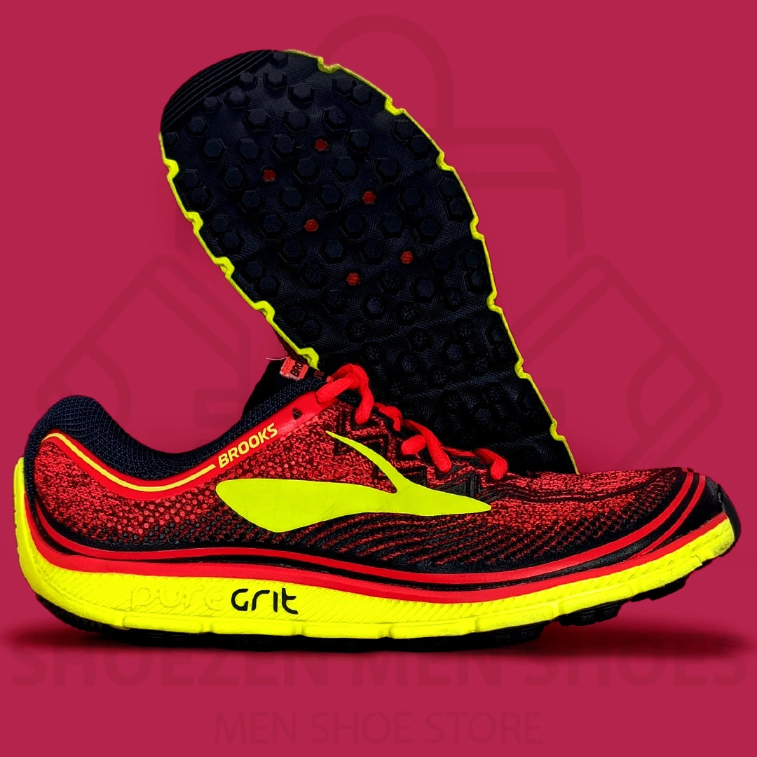 Brooks PureGrit 6 Shoes - Shoezen  Men Shoes - Black, red, and yellow running shoe on a pink background