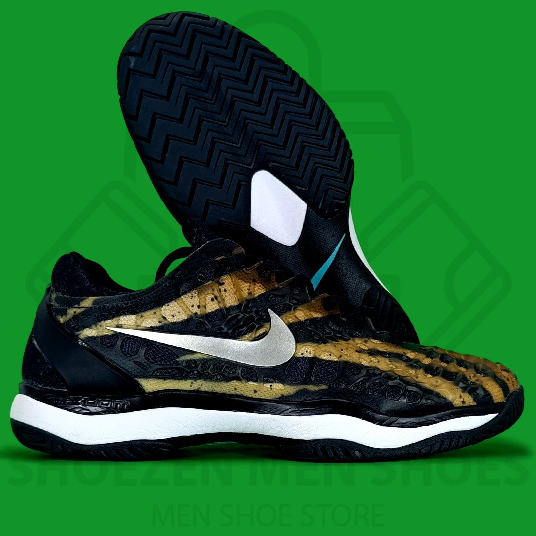 Nike Air Zoom Cage 3 HC Leopard Joggers - Shoezen Men Shoes - Black and gold sneaker with a white Nike logo on a green background