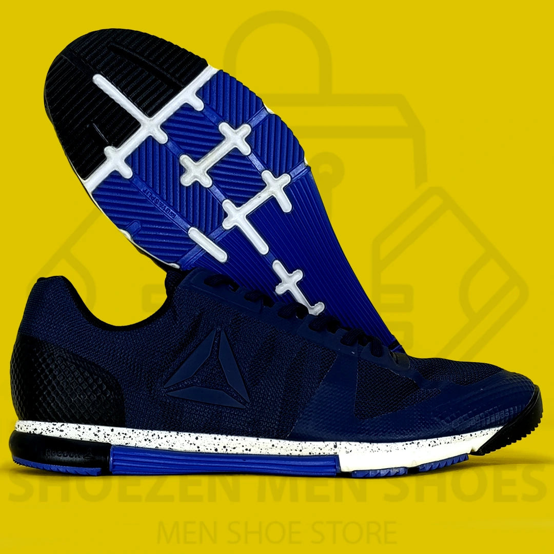 REBK R CROSSFIT SPEED TR 2.0 JOGGERS - Shoezen Men Shoes - Navy and blue athletic shoes with white sole on a yellow background