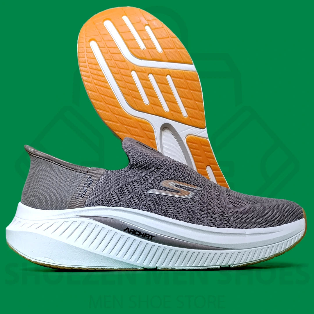 TRENDY SLIP-INS SKECHERS - SHOEZEN MEN SHOES - Gray athletic shoe with orange sole on a green background