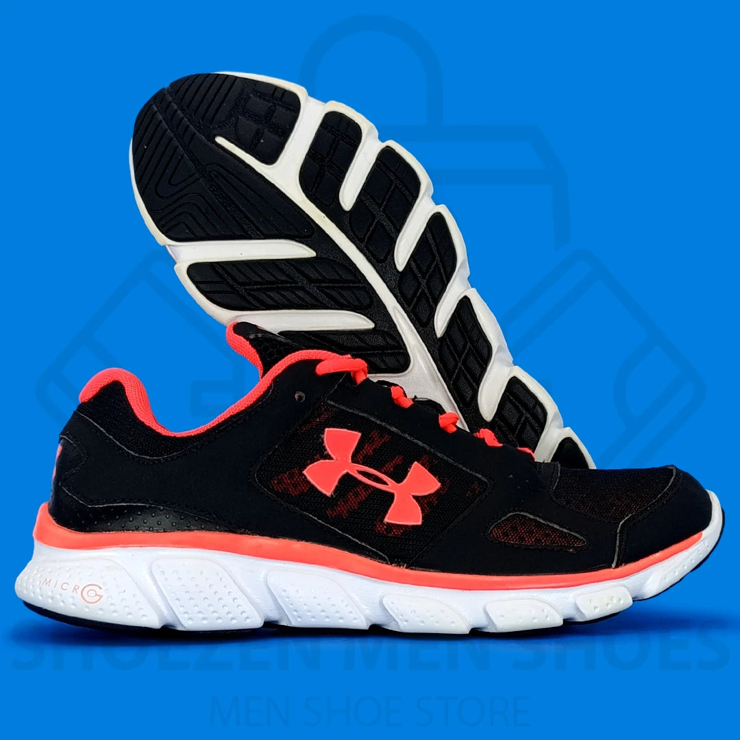 UA Micro G Assert V Running Shoes - Shoezen Men Shoes - Black and red running shoes with a visible Under Armour logo on a blue background