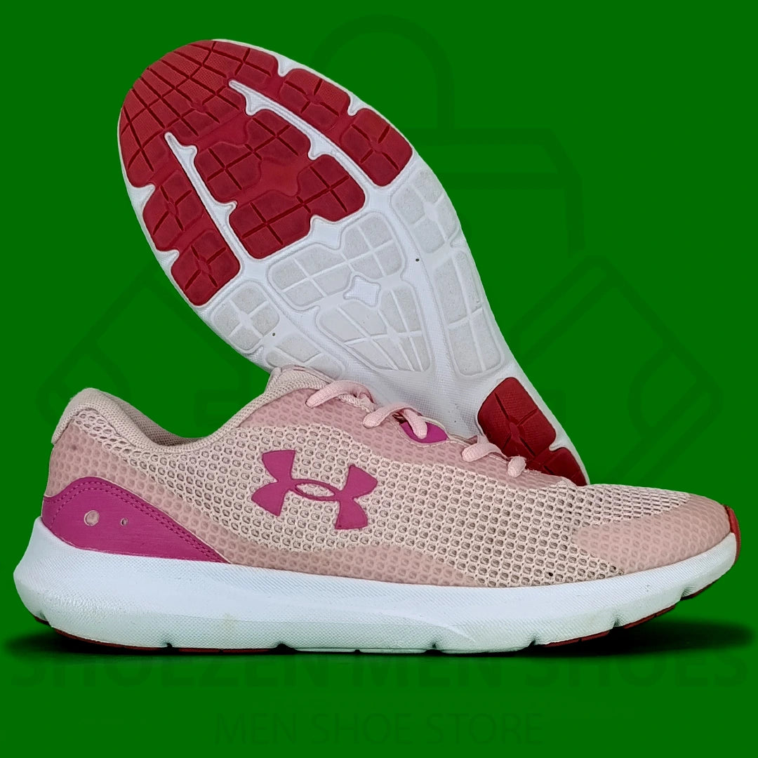 Women's UA Surge 3 Running Shoes - Shoezen Men Shoes - Pink running shoe with a white sole on a green background