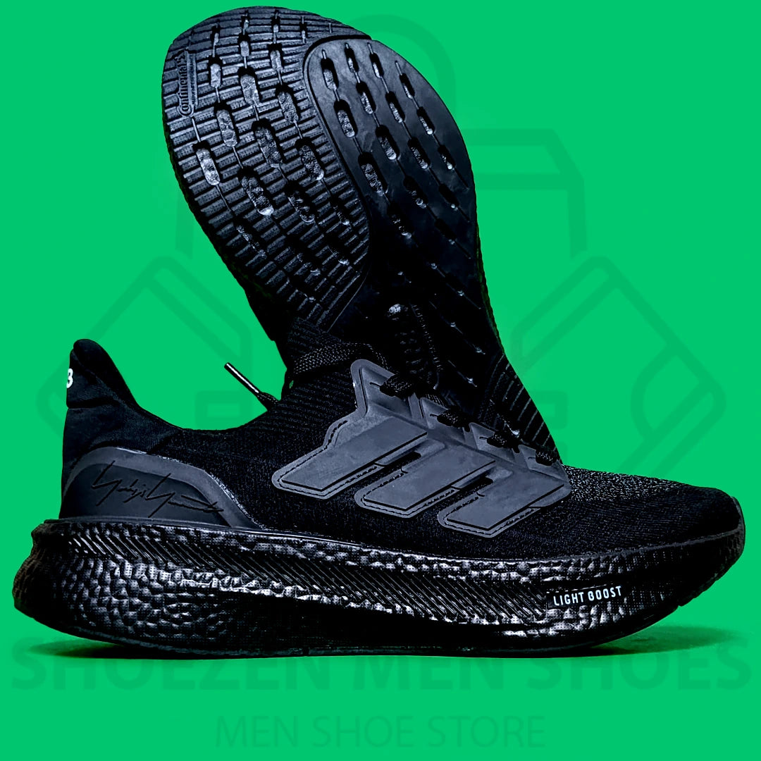 ADI LIGHT BOOST JOGGERS - SHOEZEN MEN SHOES - Black Adidas sneaker on a green background