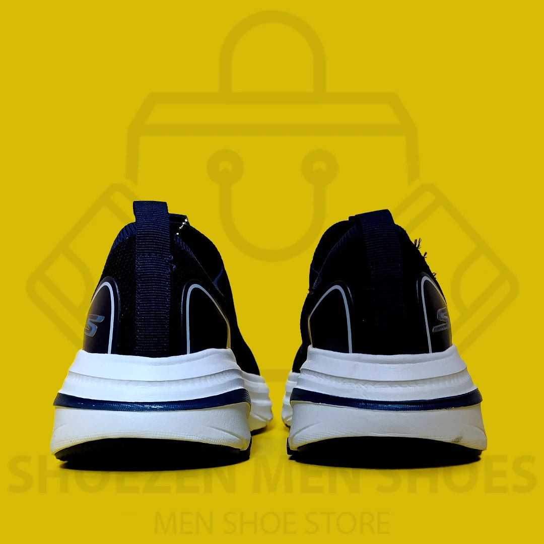 ARCHFIT MAX CUSHION SKECHERS - SHOEZEN MEN SHOES - Navy running shoe with white sole on a yellow background