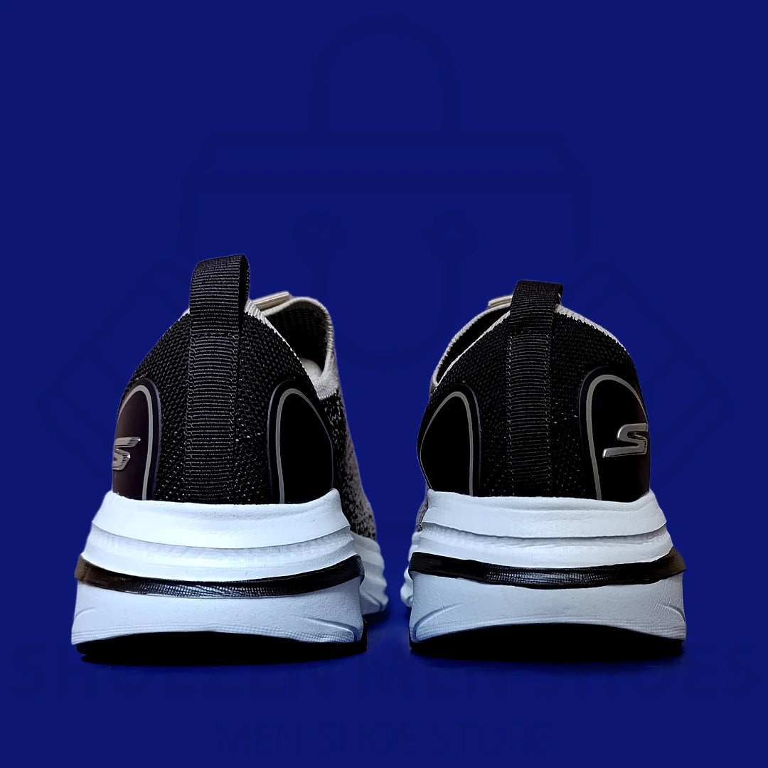 ARCHFIT MAX CUSHION SKECHERS - SHOEZEN MEN SHOES - Gray and black running shoe with white sole on a blue background