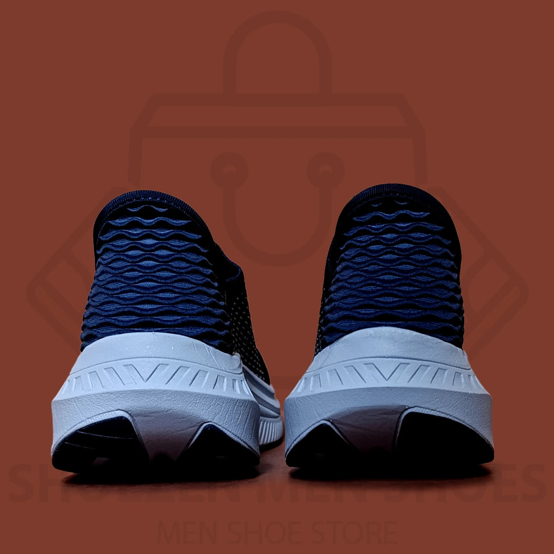 ARCHFIT SLIP-INS SKECHERS  - SHOEZEN MEN SHOES - Navy running shoes with white soles on a brown background