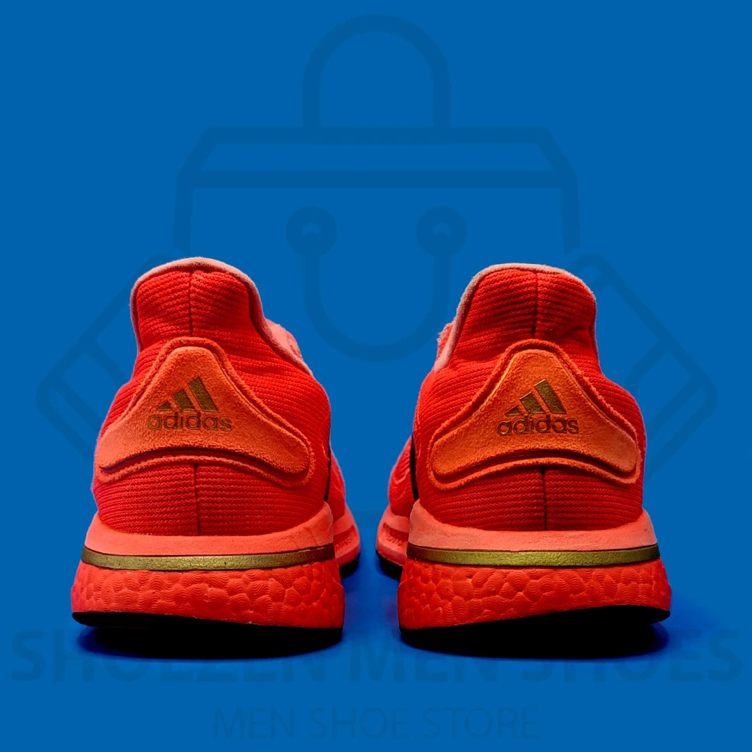 Adi Supernova M 'Red' Joggers - Shoezen Men Shoes - Red running shoe with black accents on a blue background