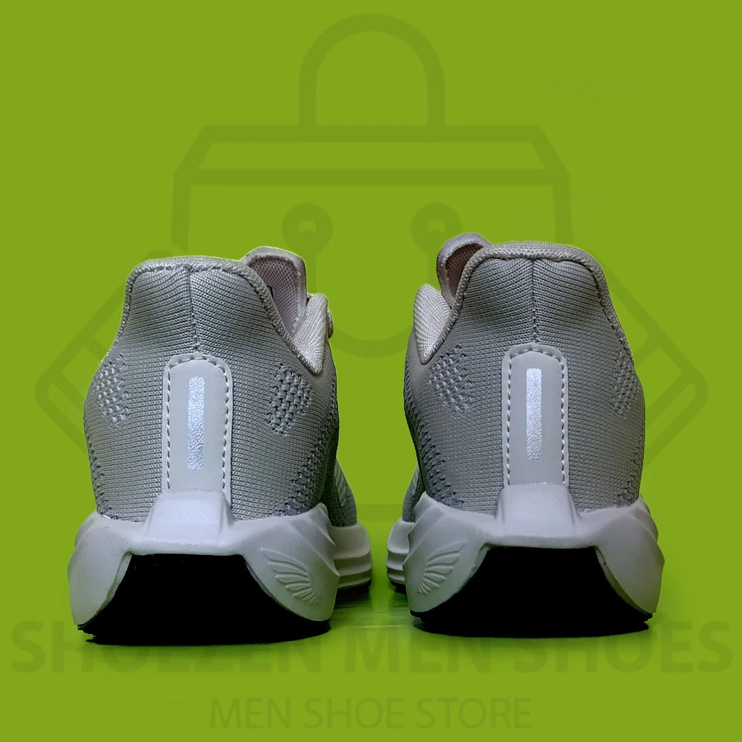 NK PEGASUS TURBO JOGGERS - SHOEZEN MEN SHOES - Gray running shoe with black sole on a green background