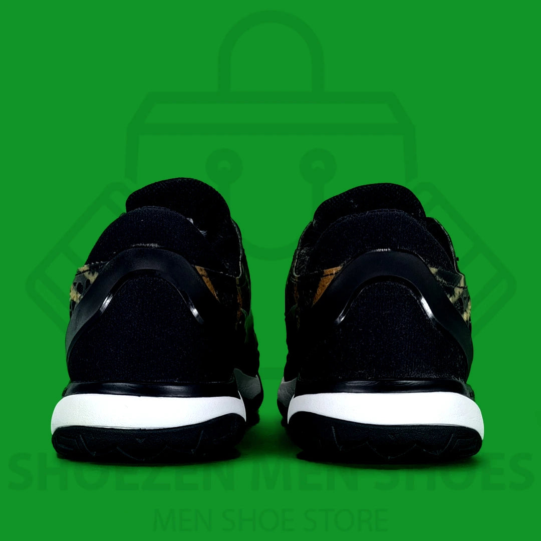 Nike Air Zoom Cage 3 HC Leopard Joggers - Shoezen Men Shoes - Black and gold sneaker with a white Nike logo on a green background