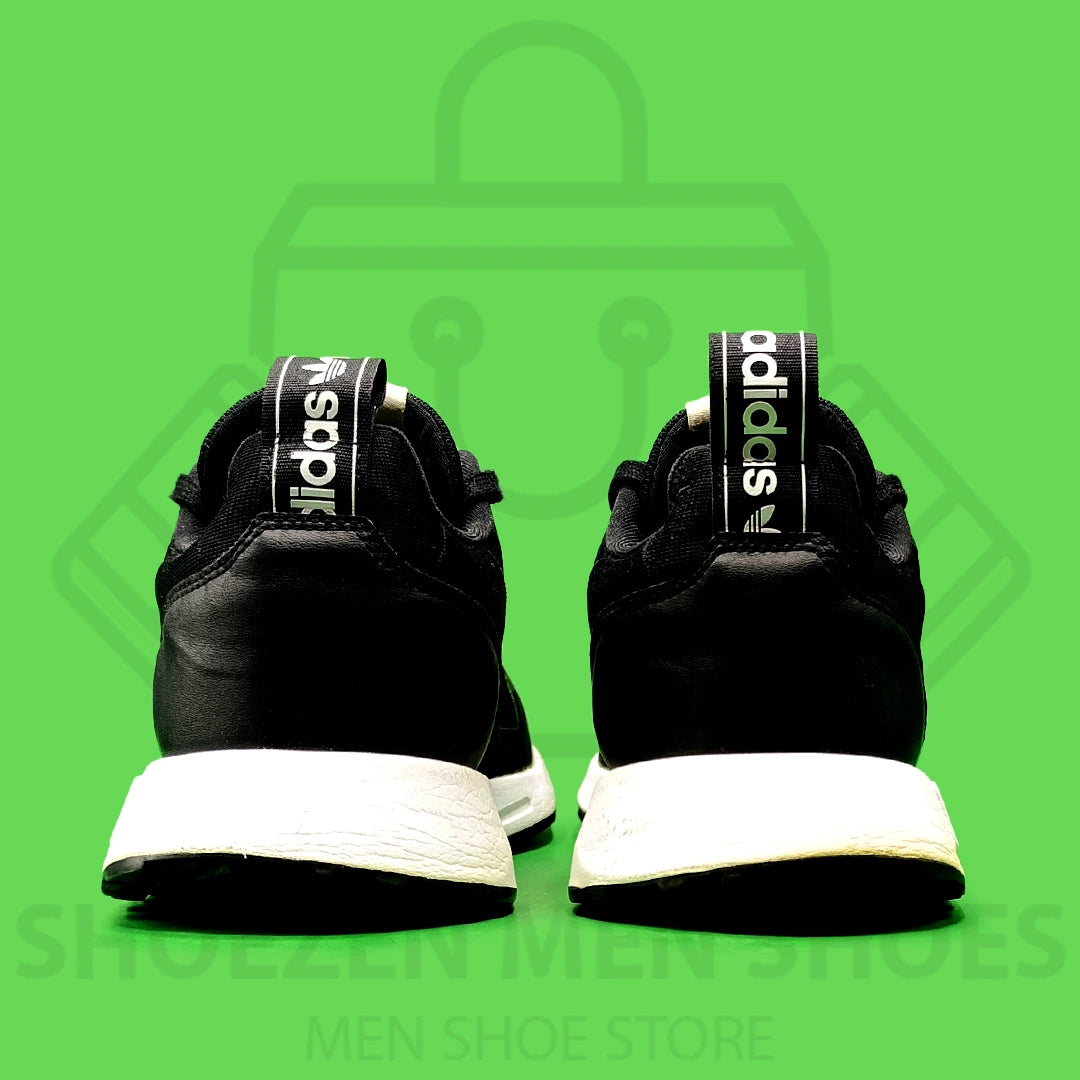 Nk Multix Shoes - Shoezen Men Shoes - Black Adidas sneaker with white stripes on a green background