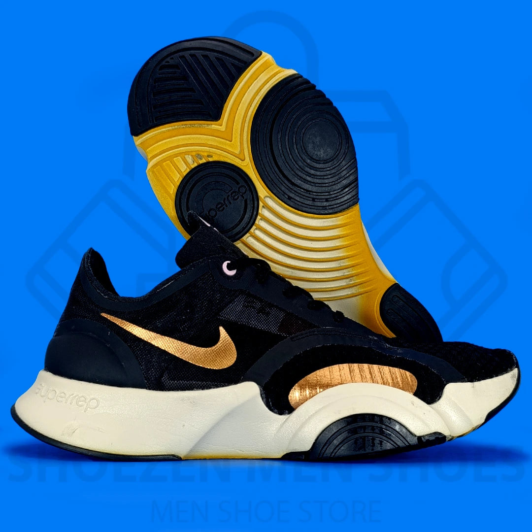 Nk Superrep Go Training Shoes - Shoezen Men Shoes - Black and gold sneakers with a visible brand logo on a blue background