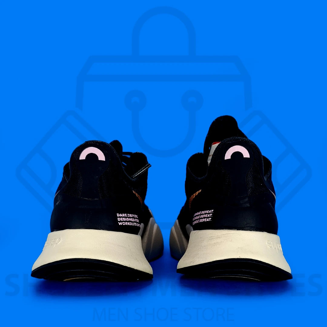 Nk Superrep Go Training Shoes - Shoezen Men Shoes - Black and gold sneakers with a visible brand logo on a blue background