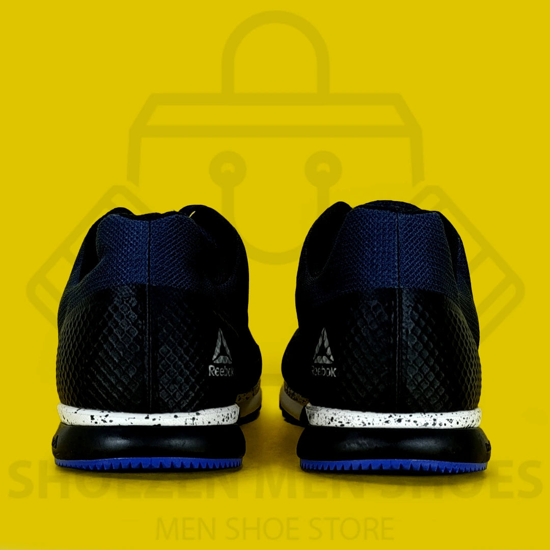 REBK R CROSSFIT SPEED TR 2.0 JOGGERS - Shoezen Men Shoes - Navy and blue athletic shoes with white sole on a yellow background