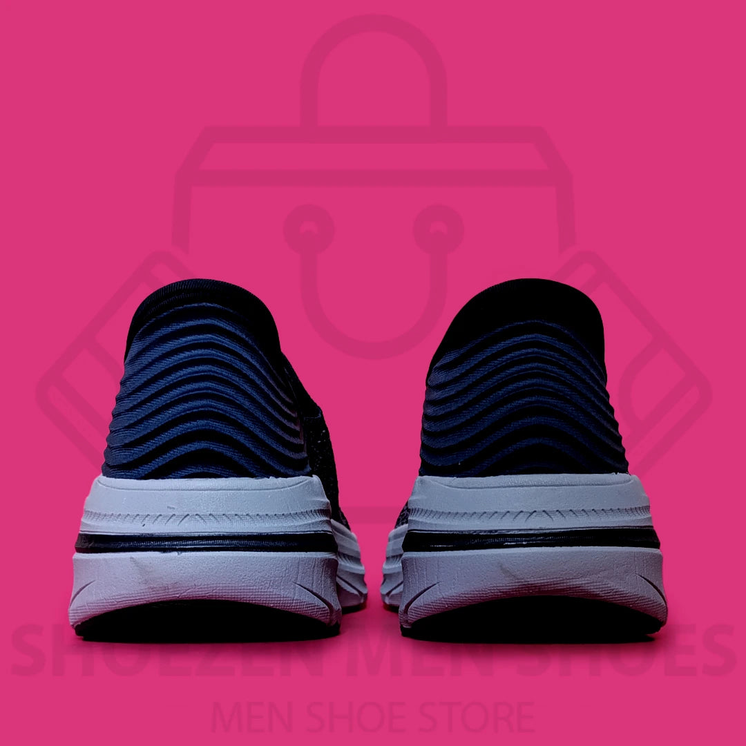 TRENDY ARCHFIT SKECHERS - SHOEZEN MEN SHOES - Navy running shoe with white sole on a pink background