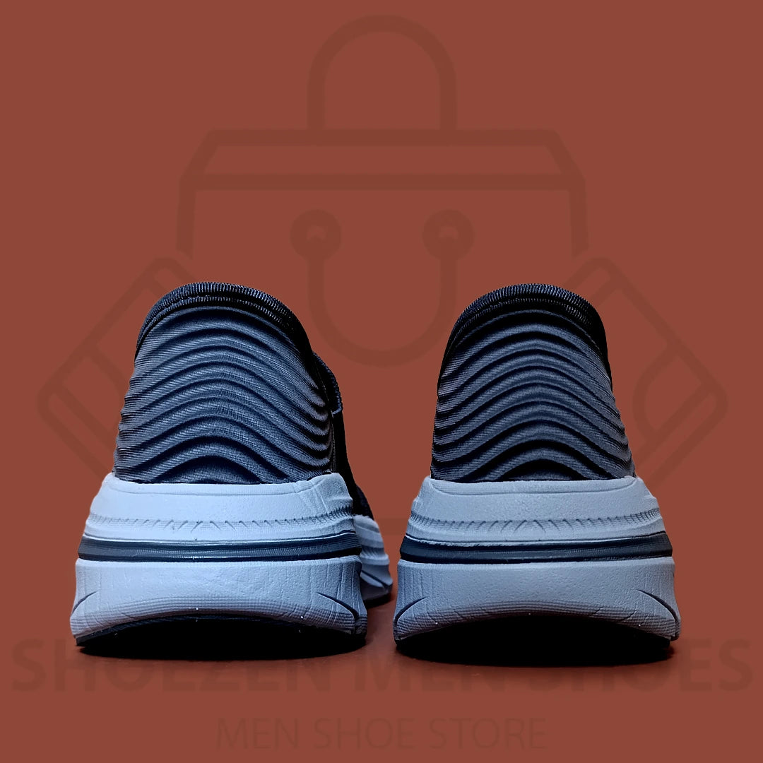 TRENDY ARCHFIT SKECHERS - SHOEZEN MEN SHOES - Navy running shoe with white sole on a brown background