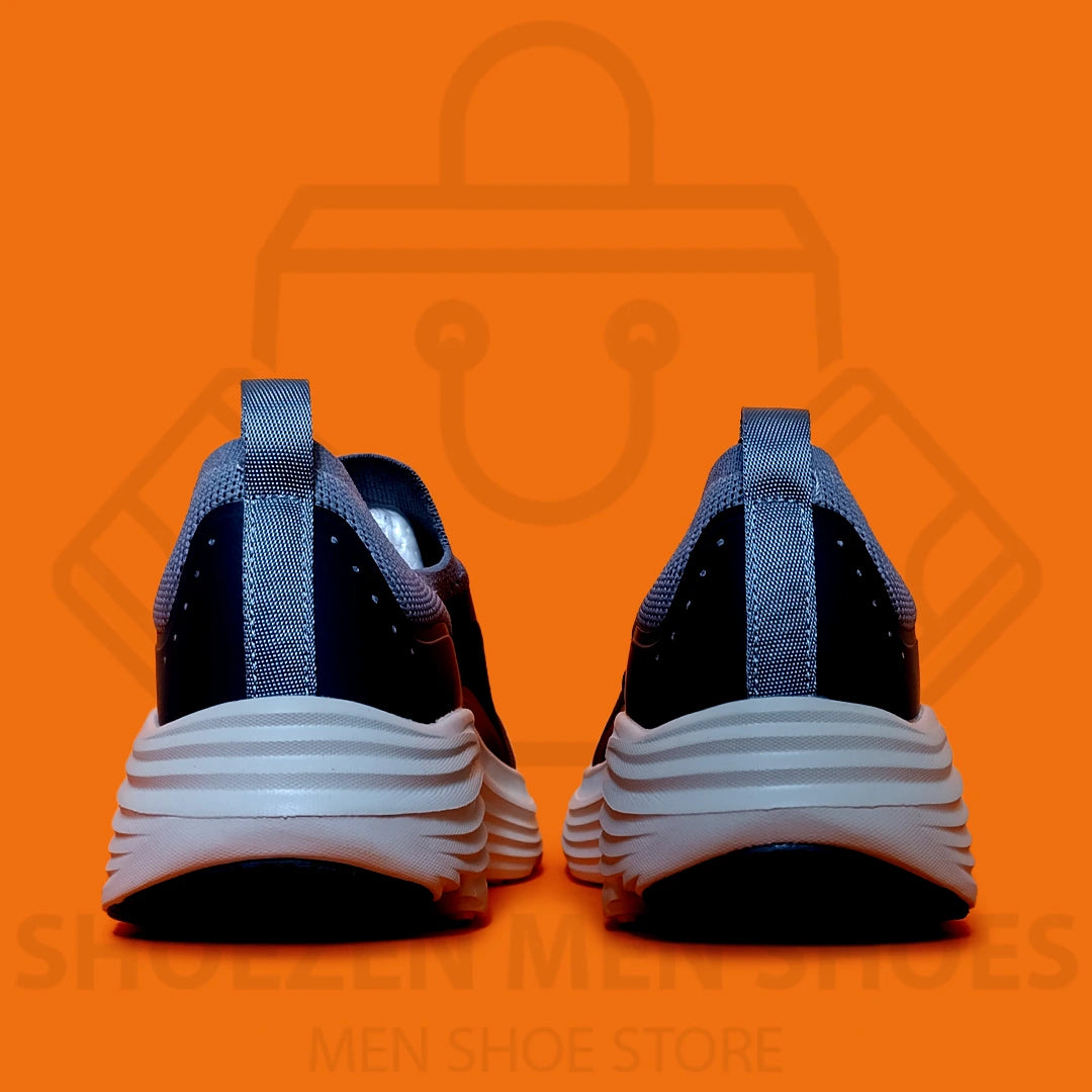 TRENDY MAX CUSHION SKECHERS - SHOEZEN MEN SHOES - Blue and navy running shoe with white sole on an orange background