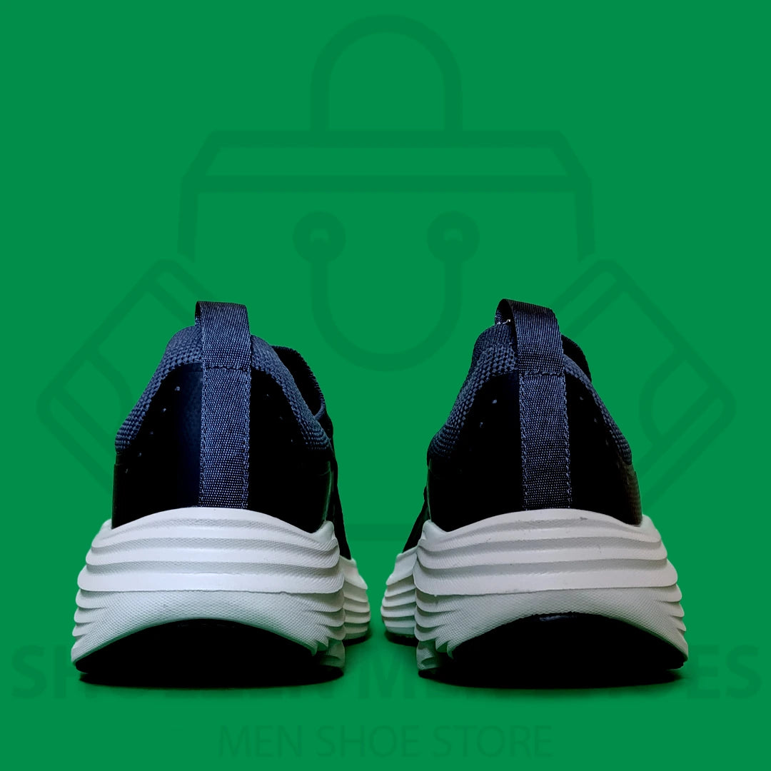 TRENDY MAX CUSHION SKECHERS - SHOEZEN MEN SHOES - Navy and black running shoe with white sole on a green background