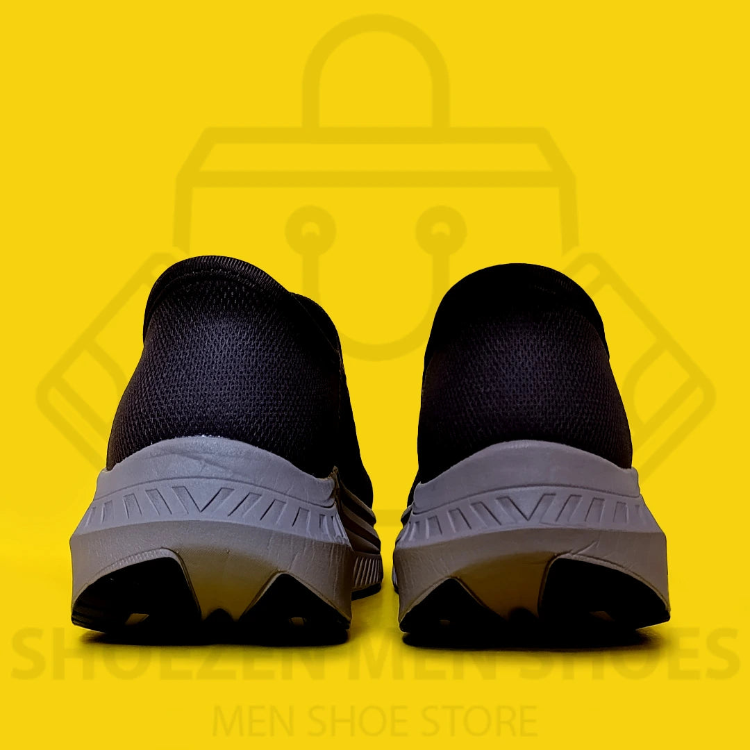 TRENDY SLIP-INS SKECHERS - SHOEZEN MEN SHOES - Black slip-on shoe with white sole on a yellow background