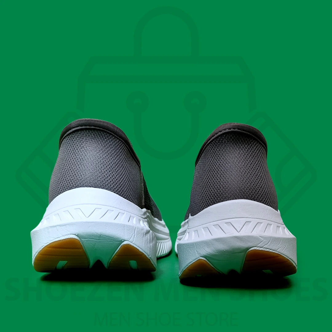 TRENDY SLIP-INS SKECHERS - SHOEZEN MEN SHOES - Gray athletic shoe with orange sole on a green background