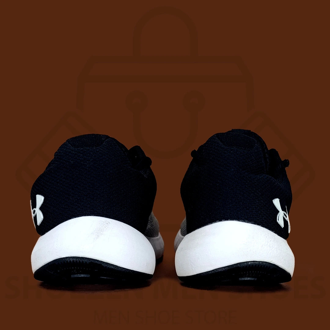 UA Men's Micro G Pursuit Running Shoes - Shoezen Men Shoes - Gray and black sneaker with Under Armour logo on a brown background