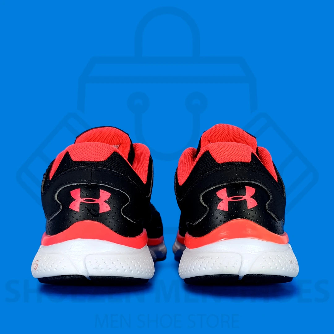 UA Micro G Assert V Running Shoes - Shoezen Men Shoes - Black and red running shoes with a visible Under Armour logo on a blue background
