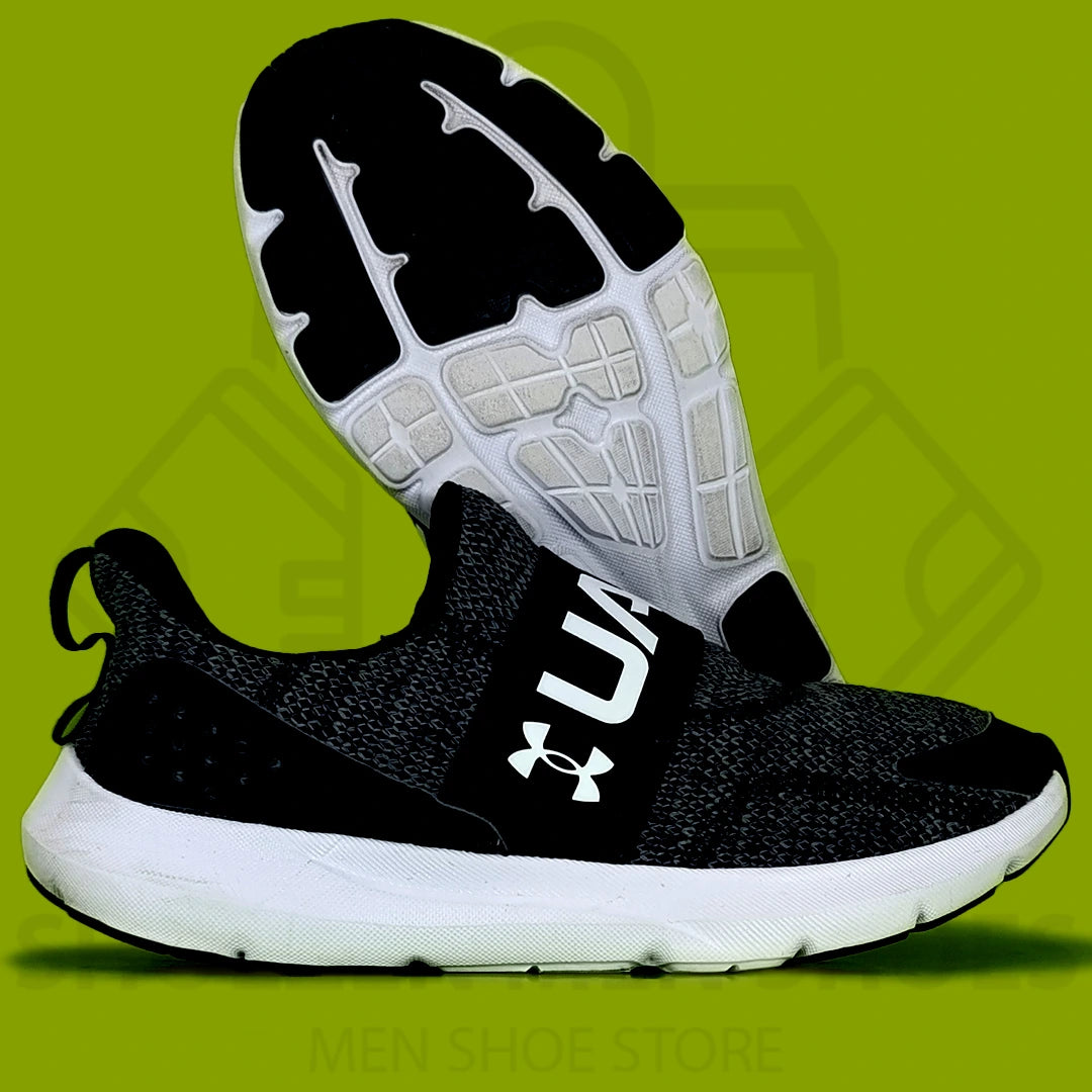 UA Surge 3 Slip Skechers - Shoezen Men Shoes - Black and white athletic shoe with brand logo on a green background